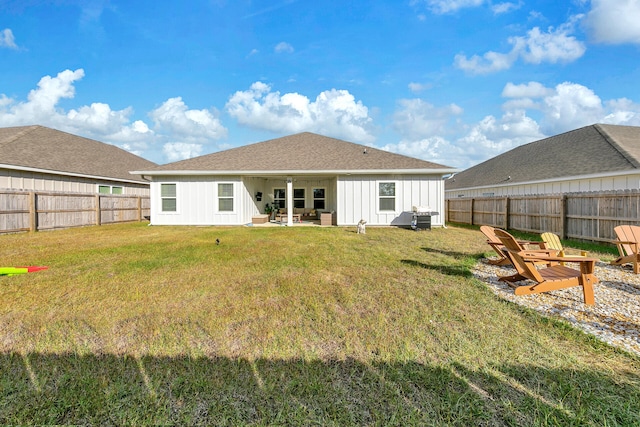 rear view of house featuring a patio and a lawn