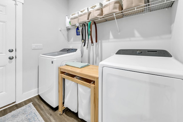 laundry room with dark hardwood / wood-style floors and washer and clothes dryer