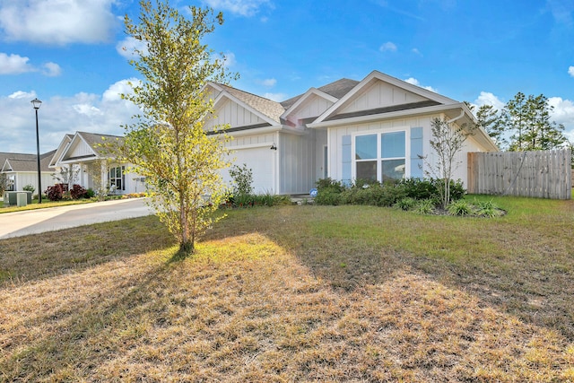 view of front of property with a garage and a front lawn