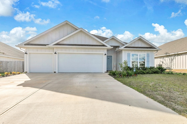 view of front of home with a front yard and a garage