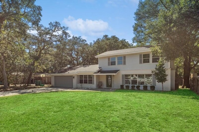 rear view of property with a lawn and a garage