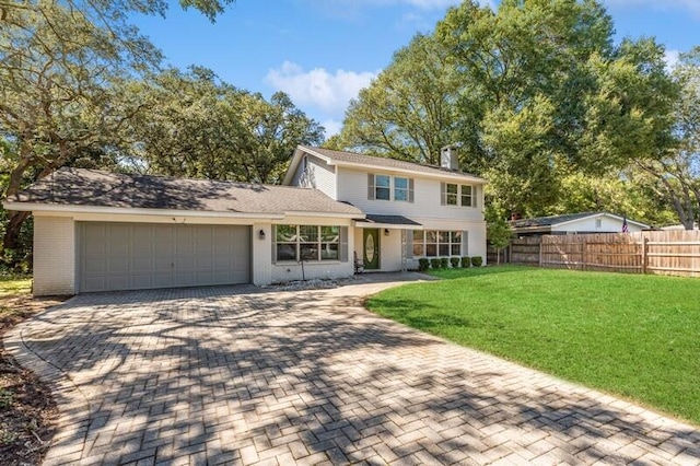 view of front of house with a garage and a front lawn