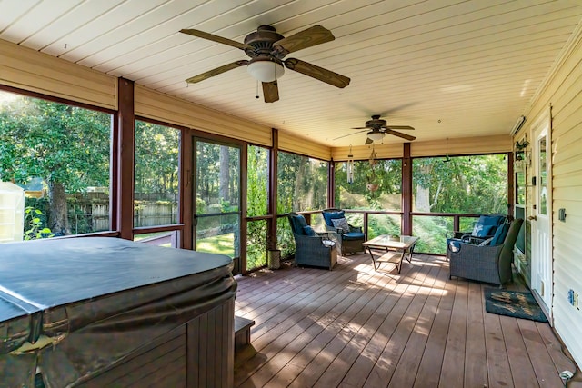 unfurnished sunroom featuring a water view and ceiling fan