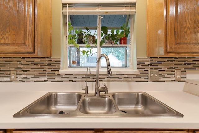 room details featuring sink and decorative backsplash