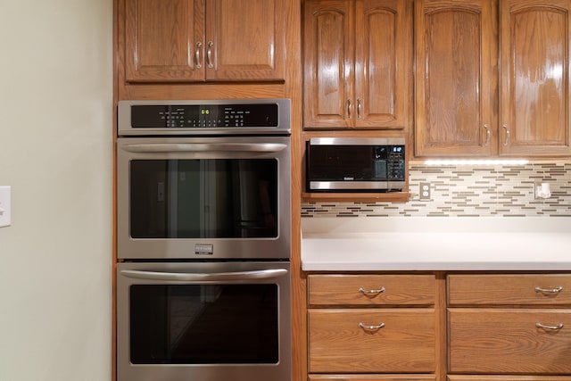 kitchen featuring decorative backsplash and appliances with stainless steel finishes