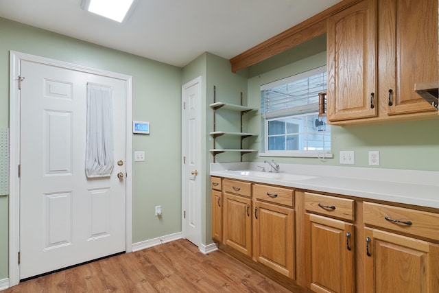 kitchen with sink and light hardwood / wood-style floors