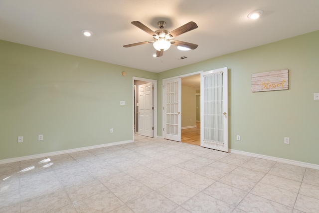 spare room with french doors and ceiling fan