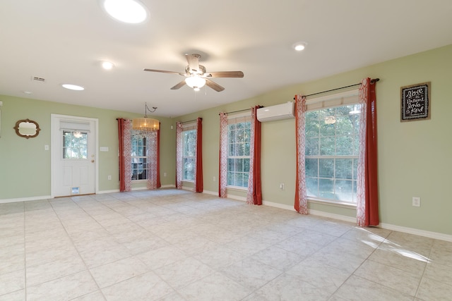 interior space with a wall mounted air conditioner and ceiling fan