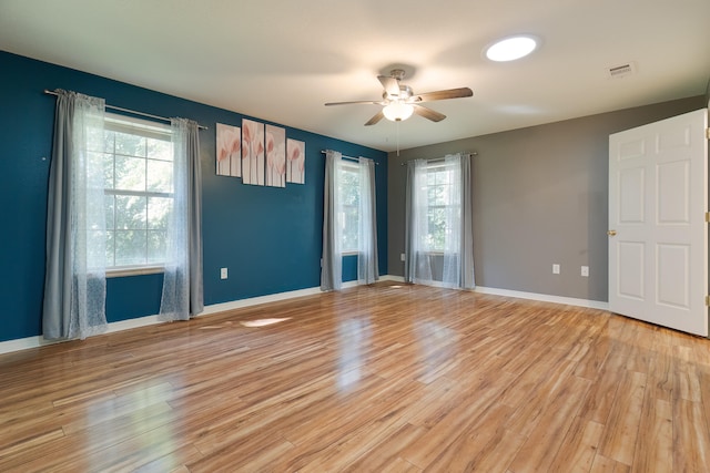 empty room featuring ceiling fan and light wood-type flooring