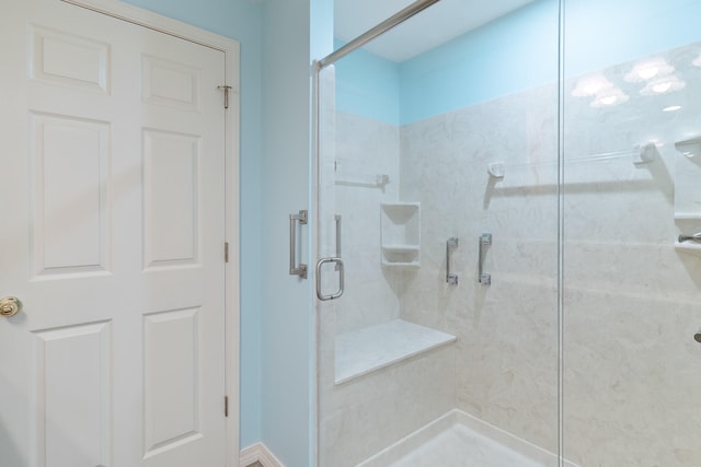 bathroom with a shower with shower door