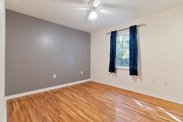 empty room with hardwood / wood-style flooring and ceiling fan