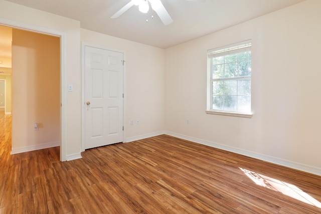 empty room featuring hardwood / wood-style floors and ceiling fan