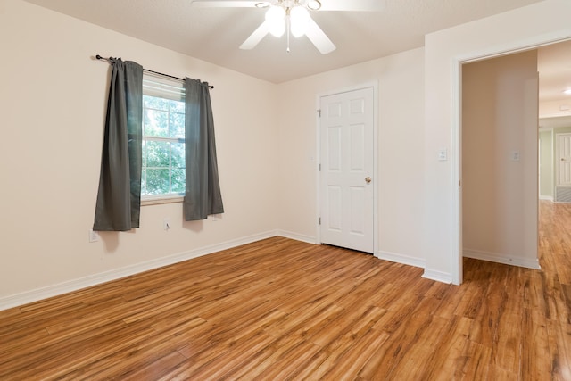 unfurnished bedroom featuring ceiling fan, a closet, and light hardwood / wood-style floors