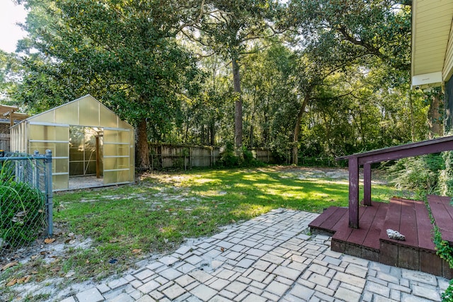 view of yard with a shed and a patio