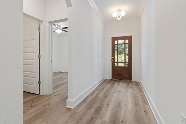 entrance foyer with ornamental molding and light wood-type flooring