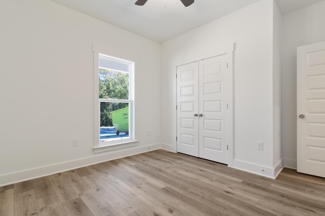 unfurnished bedroom with ceiling fan, light hardwood / wood-style floors, and a closet