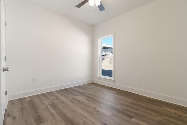 empty room with ceiling fan and hardwood / wood-style floors