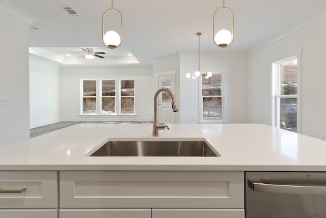 kitchen featuring dishwasher, sink, hanging light fixtures, ornamental molding, and a tray ceiling