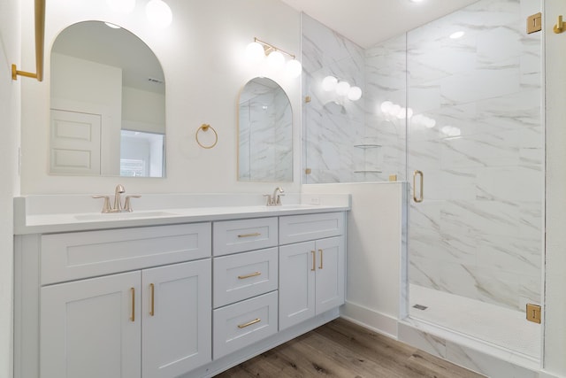 bathroom featuring vanity, a shower with door, and hardwood / wood-style floors