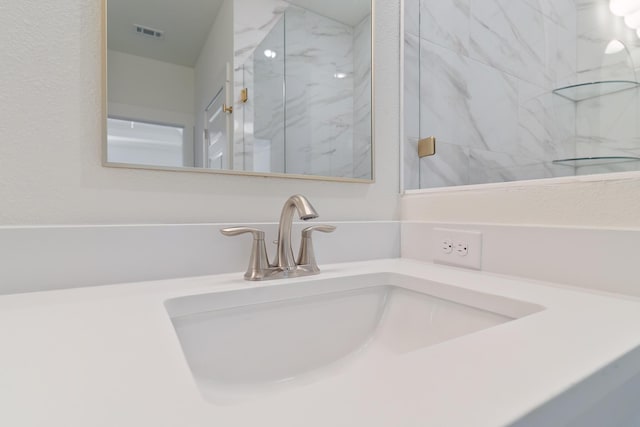 bathroom featuring vanity and a tile shower