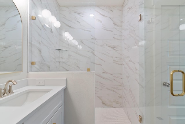 bathroom featuring vanity and a shower with shower door