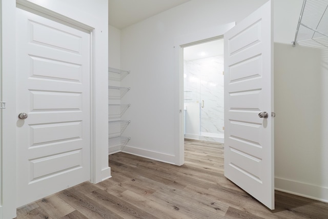 walk in closet featuring light hardwood / wood-style flooring