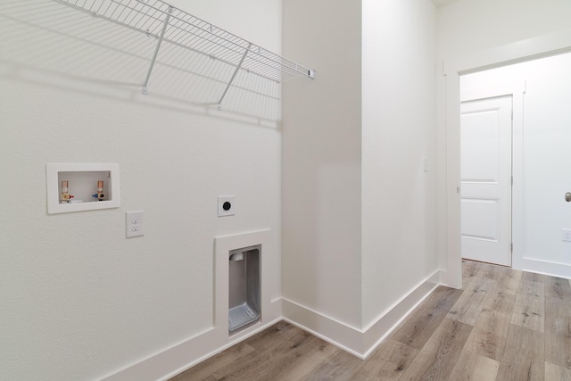 washroom with washer hookup, light hardwood / wood-style flooring, and electric dryer hookup