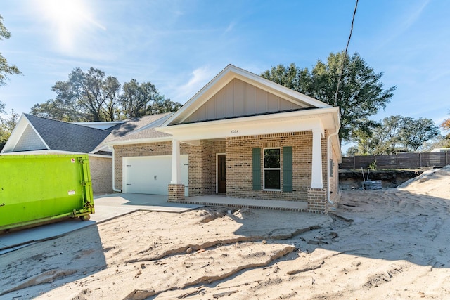 view of front of property featuring a garage and covered porch