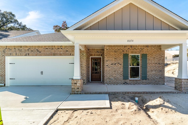 view of front of property with a garage and covered porch