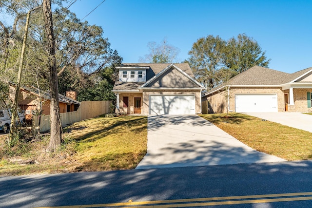 view of front of house featuring a garage, concrete driveway, fence, a front lawn, and brick siding