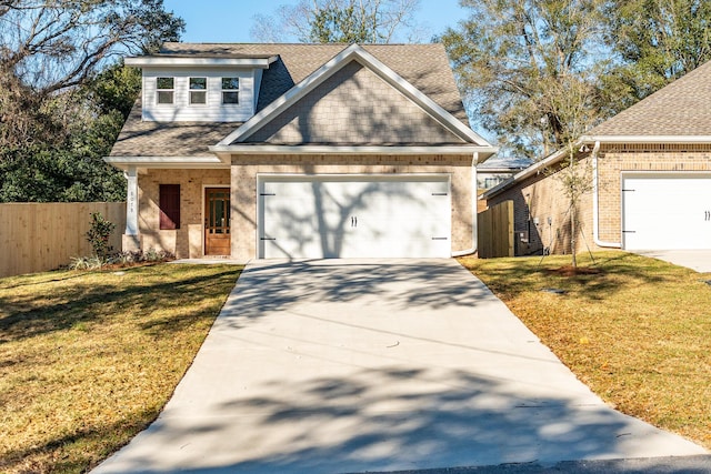 view of front of property with a front yard, concrete driveway, fence, and an attached garage