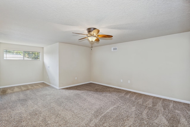 unfurnished room featuring ceiling fan, a textured ceiling, and carpet floors