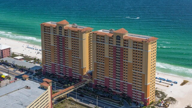 birds eye view of property featuring a view of the beach and a water view