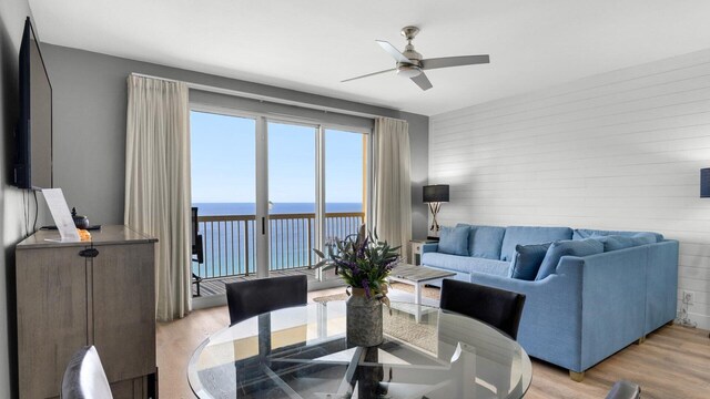 dining space featuring a water view, ceiling fan, and light hardwood / wood-style flooring