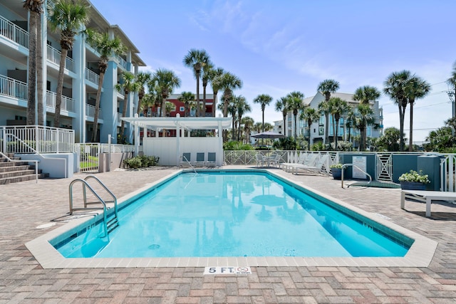 view of swimming pool featuring a patio area