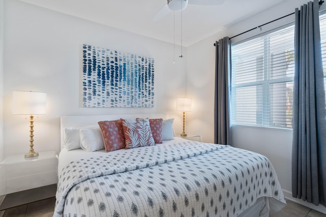 bedroom with ceiling fan and tile patterned floors