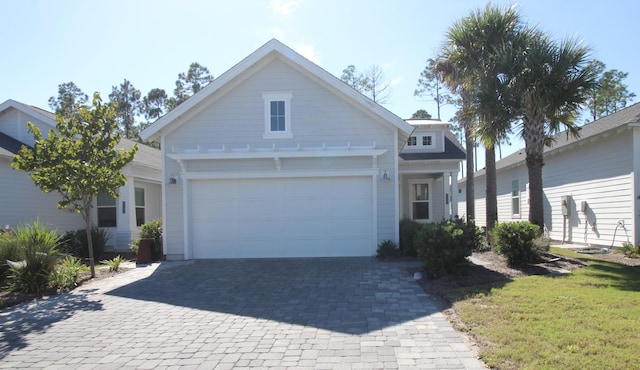 view of front of home with a garage and a front lawn