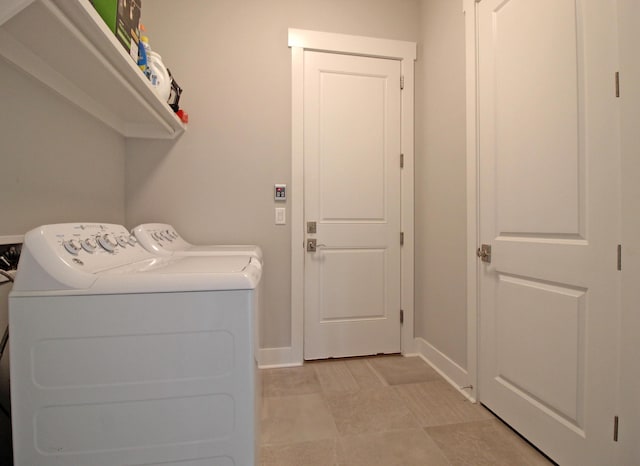 laundry area featuring washing machine and clothes dryer