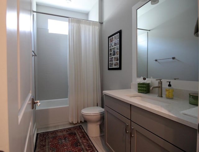 full bathroom featuring shower / tub combo, vanity, and toilet