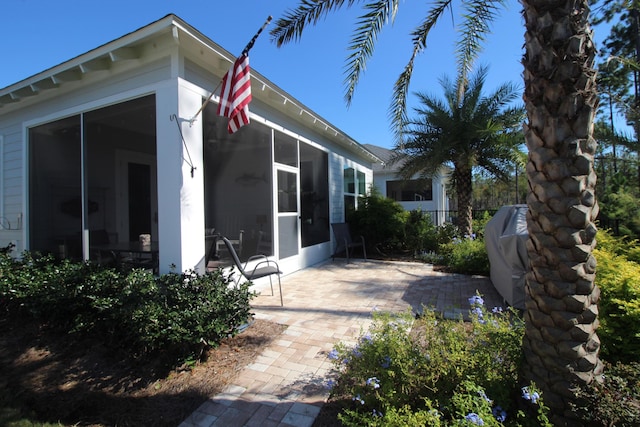 view of patio / terrace featuring a sunroom