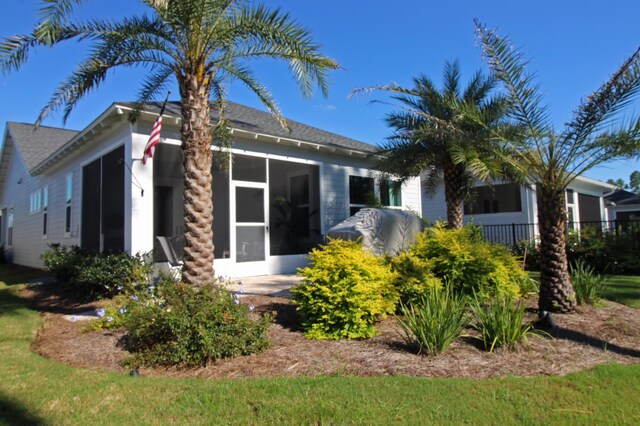 back of property featuring a sunroom