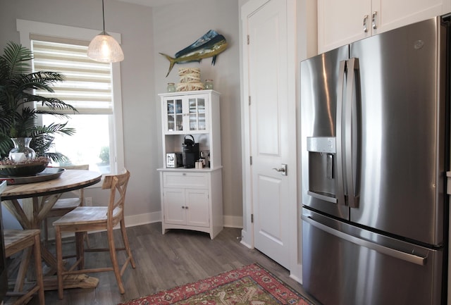 kitchen with hanging light fixtures, white cabinetry, dark hardwood / wood-style floors, and stainless steel fridge with ice dispenser