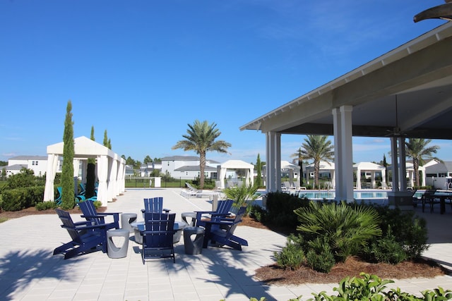 view of patio with a gazebo and a community pool