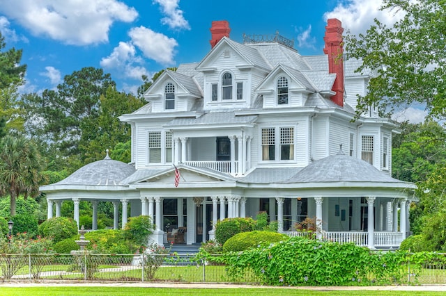 victorian house with covered porch and a balcony