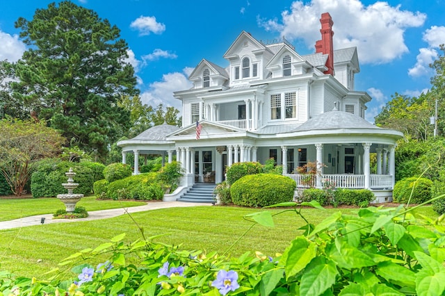 victorian-style house with covered porch and a front yard