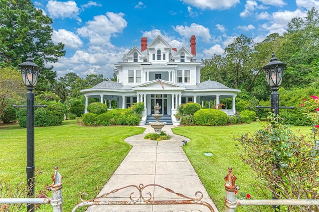 victorian house with a porch and a front lawn