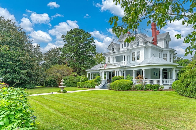 victorian-style house featuring a front yard and covered porch