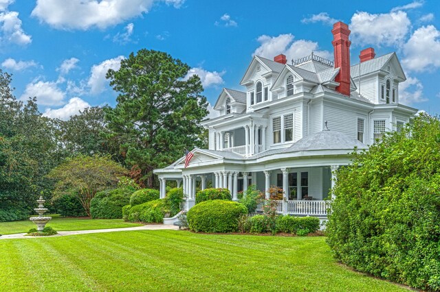 view of front of house with a front yard and a porch