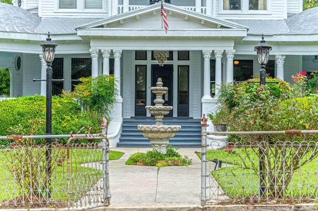 view of exterior entry featuring covered porch