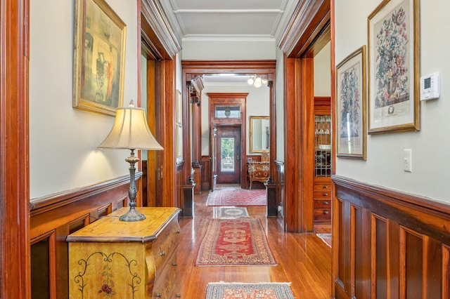 hallway featuring ornamental molding and hardwood / wood-style floors